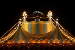 Circus,tent,at,night,with,its,colorful,lights,on