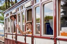 Beautiful,children,,dressed,in,vintage,clothes,,enjoying,old,steam,train