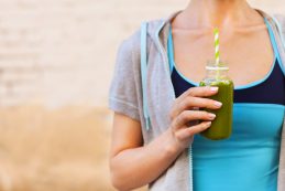 Woman,drinking,vegetable,smoothie,after,fitness,running,workout,on,summer