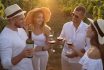 Friends,tasting,red,wine,in,vineyard,on,sunny,day
