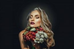 Portrait,of,attractive,grey,hair,woman,with,flowers,in,studio
