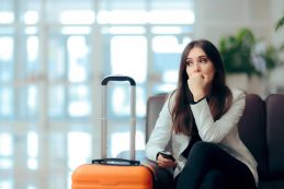 Sad,melancholic,woman,with,suitcase,in,airport,waiting,room.,upset