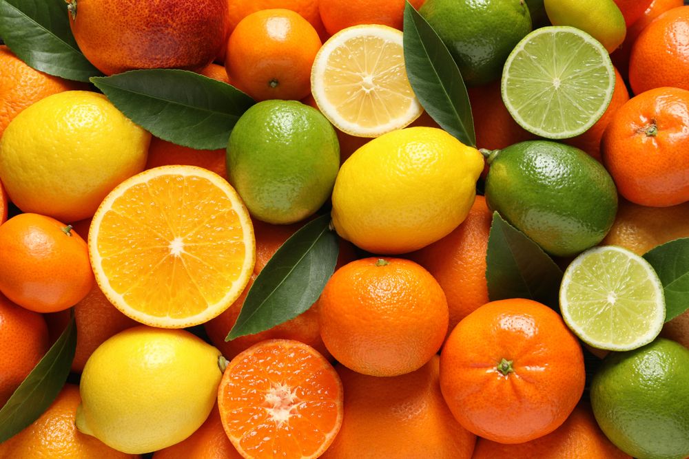 Different,citrus,fruits,with,leaves,as,background,,top,view