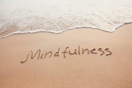 Mindfulness,concept,,mindful,living,,text,written,on,the,sand,of