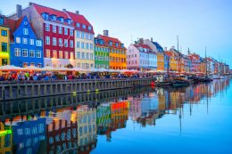People,walking,and,sitting,in,restaurants,at,illuminated,nyhavn,embankment