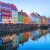 People,walking,and,sitting,in,restaurants,at,illuminated,nyhavn,embankment