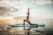 Young,woman,doing,yoga,on,a,sup,board,in,the