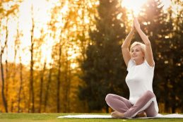 Happy,mature,woman,practicing,yoga,in,park.,active,lifestyle