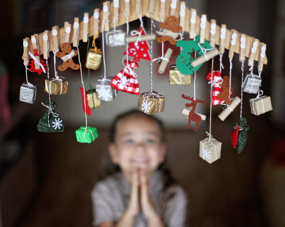 Cute,little,kid,stretching,for,advent,calendar,with,small,gifts.