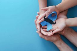 Family,hands,holding,light,blue,ribbonwith,mustache,on,blue,background