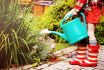 Little,girl,in,a,garden,with,green,watering,pot
