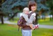 Young,mother,with,her,toddler,child,in,a,baby,carrier