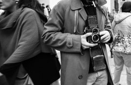 Hipster,guy,with,the,vintage,camera,photographing,people,in,the