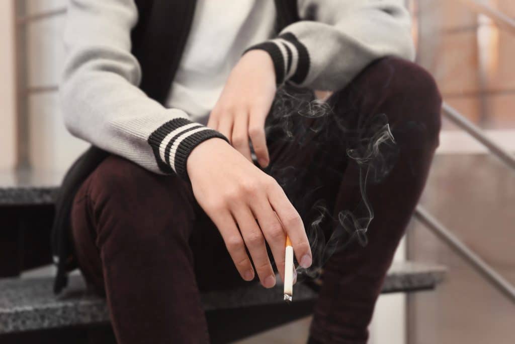 Teenage,boy,holding,cigarette,,closeup