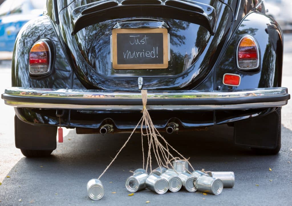 Vintage,wedding,car,with,just,married,sign,and,cans,attached