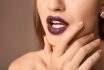 Beautiful,young,woman,with,dark,lipstick,on,color,background,,closeup