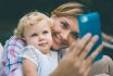Young,beautiful,mother,takes,selfie,with,her,daughter,during,a