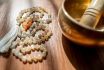Handmade,sacred,mala,seed,beads,and,a,golden,tibetan,bowl