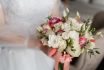 Bride,holding,wedding,bouquet,from,white,and,pink,flowers