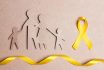 Cardboard,silhouette,of,a,family,with,yellow,awareness,ribbon,on