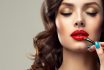 Makeup,artist,applies,red,lipstick,.,beautiful,woman,face.,hand