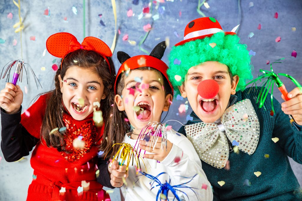 Three,kids,celebrating,carnival,together,at,home