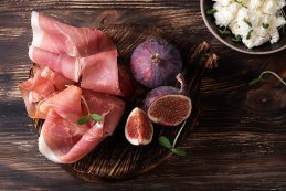 Appetizer,from,dry,cured,ham,,prosciutto,slices,with,figs,on