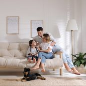 Happy,family,on,sofa,and,puppy,in,living,room