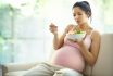 Pregnant Woman Relaxing At Home And Eating Salad.