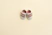 Baby Pink Shoes On Yellow Paper Background With Copy Space. Baby Clothes Concept. Top View, Flat Lay