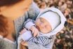 Portrait Of Mother And Baby. Sleeping Newborn Baby In The Hands Of His Mother.