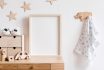 Stylish Scandi Childroom Withwooden Mock Up Photo Frame, Wooden Toys, Boxes, Blocks And Accessories Stars Pattern On The Background Wall. Bright And Sunny Interior With Wooden Desk. Home Decor.