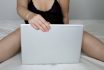 Hot Woman Sitting With Laptop In A Bed