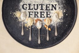 Gluten Free Written In Flour On Vintage Baking Sheet And Spoons Of Various Gluten Free Flour (almond Flour, Buckwheat Flour, Rice Flour, Corn Flour, Oatmeal Flour), Flat Lay, Top View