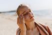 Teenage Girl Applying Sunscreen At The Beach