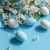 White And Blue Eggs Amidst Cherry Blossoms On A Vibrant Blue Backdrop Signifying Easter And Spring