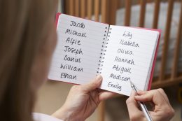 Woman Choosing Baby Names In Nursery