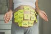 Toned Shot Of Pregnant Woman With Child Names On Belly