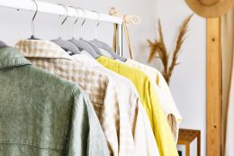 Linen Clothes On Gray Hangers On The Clothes Rack. Slow Fashion. Conscious Consumption. Crisis In The Fashion Industry, Retail. Eco Friendly, Sustainable Seasonal Sale Concept. Zero Waste.