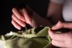 Female Hands With Sewing Needle And Thread Mending Clothes