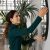 Close Up Smiling Woman Hanging Or Fixing Mirror, Decorating Apartment