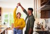 Shot Of A Young Couple Dancing Together In Their Kitchen