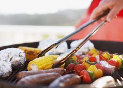 Close Up Of Man Grilling Food On Barbecue