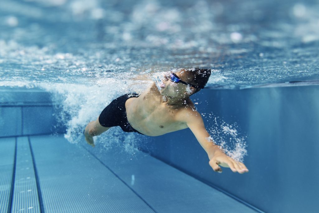 Teenage Boy Swimming Crawl In Pool