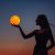 A Young Woman Holds The Full Moon In Her Hands Against The Backdrop Of A Red Sunset. Astrology