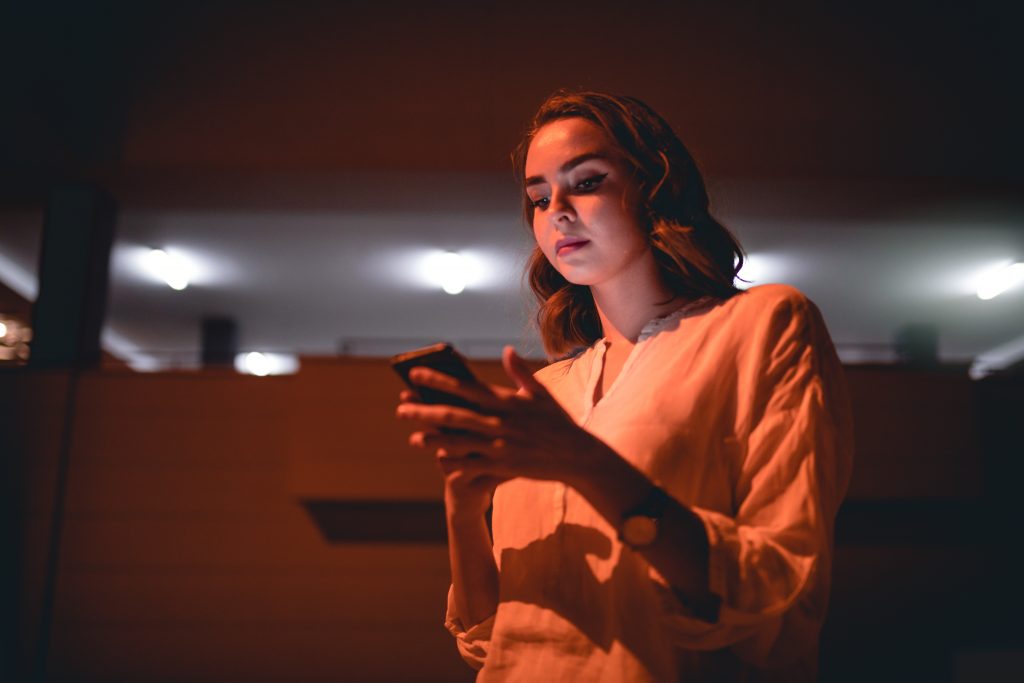 Businesswoman With A Mobile Phone Standing Outdoors