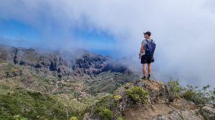 Pico Verde Man With Backpack Enjoying View On Teno Mountain Range Near Masca Village, Tenerife, Canary Islands, Spain,