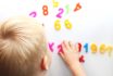 A Little Boy Is Studying The Magnetic Numbers On The Fridge. Preschooler Training