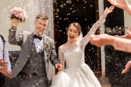 Happy Wedding Photography Of Bride And Groom At Wedding Ceremony. Wedding Tradition Sprinkled With Rice And Grain