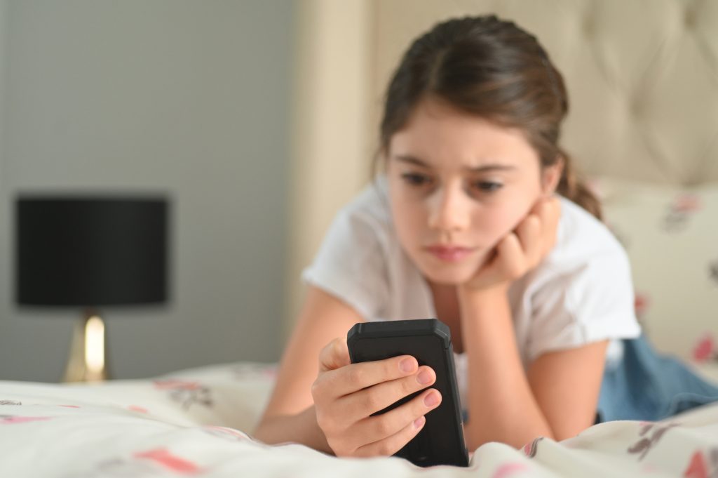 Sad Girl Reading A Bullying Post On Social Media